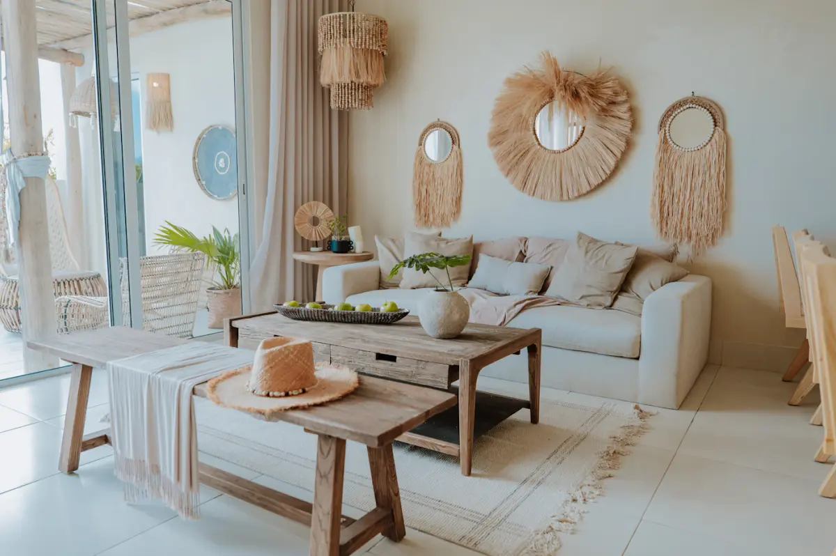 A warm, lived-in living room with soft seating, layered textiles and afternoon light